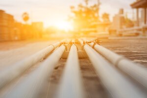 natural gas pipes extending into background with setting sun